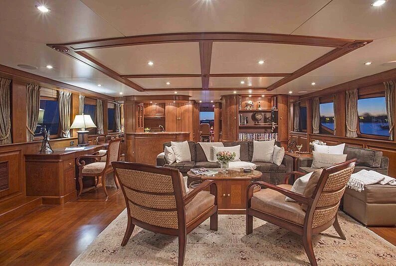 a living room with a table and chairs aboard FELICITA Yacht for Sale