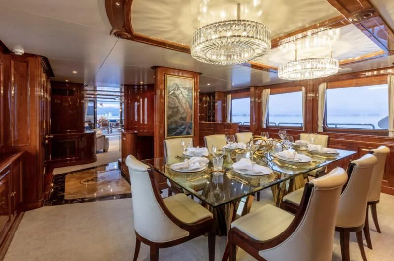 a dining room with a table set aboard FELICITA Yacht for Sale