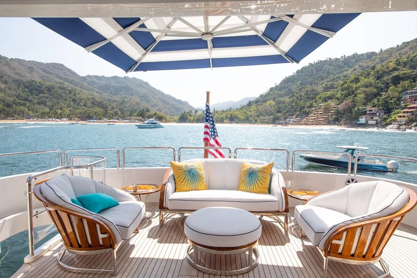 a table and chairs on a deck overlooking a body of water aboard FELICITA Yacht for Sale