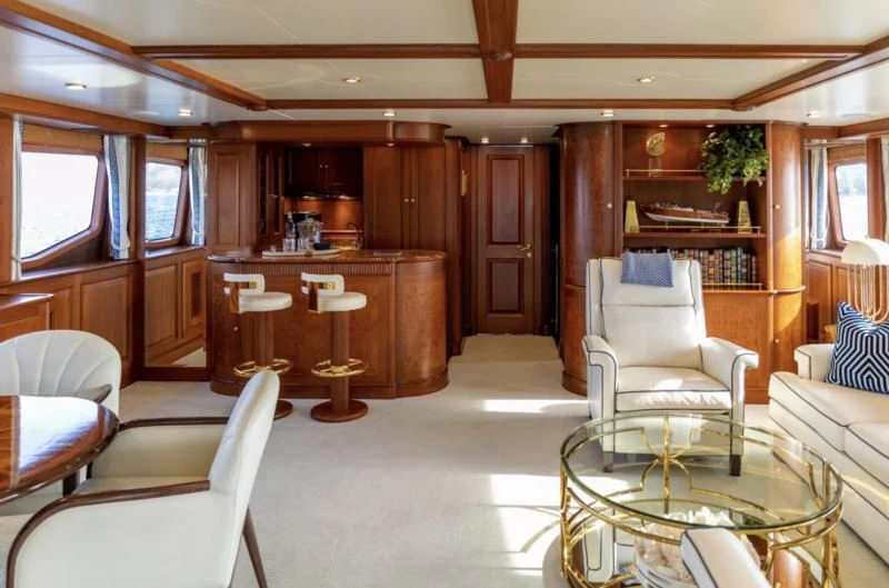 a living room with a table and chairs aboard FELICITA Yacht for Sale
