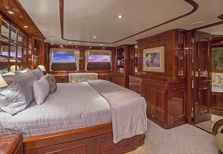 a bedroom with a bed and a mirror aboard FELICITA Yacht for Sale