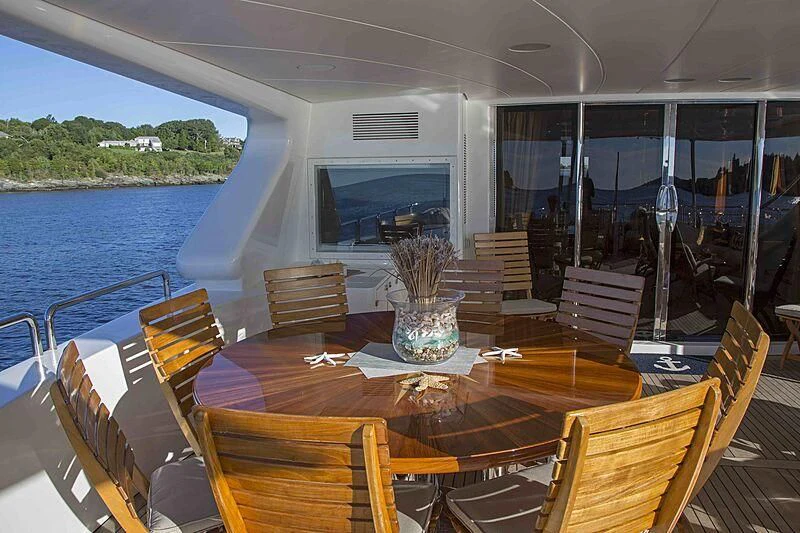a table with chairs on it aboard FELICITA Yacht for Sale
