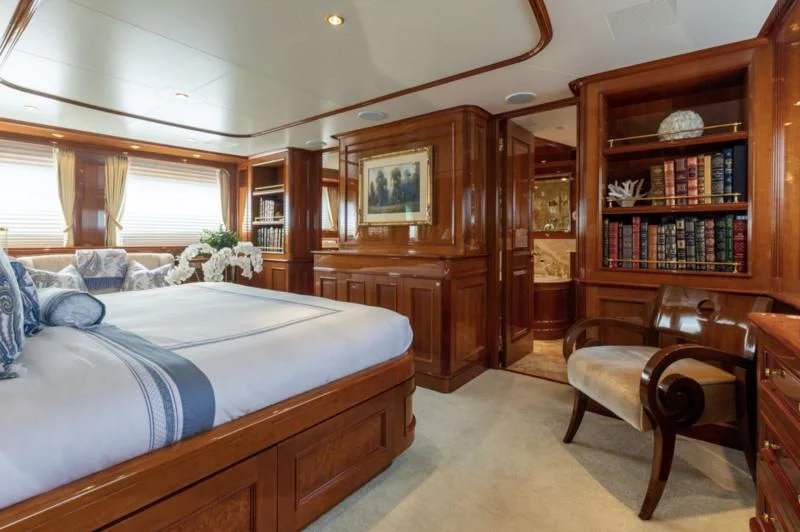 a bedroom with a bed and a bookcase aboard FELICITA Yacht for Sale
