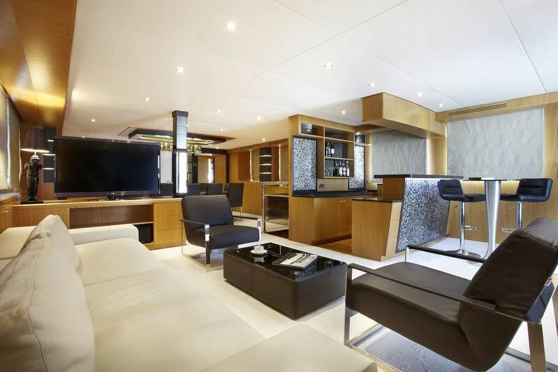 a living room with a couch and a tv aboard STAR OF THE SEA Yacht for Sale
