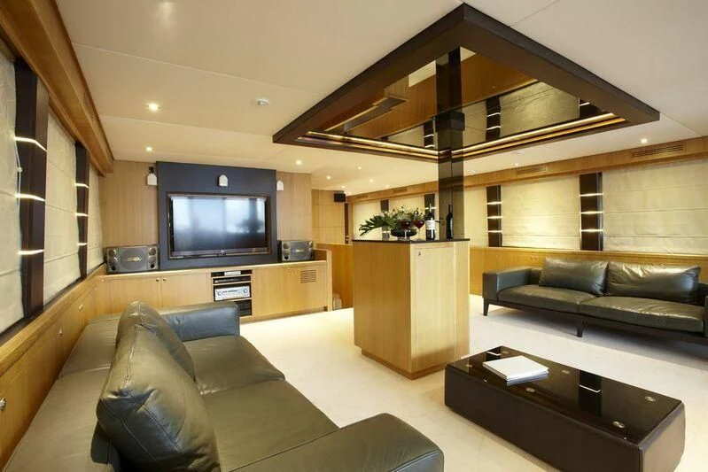 a room with a couch and a tv aboard STAR OF THE SEA Yacht for Sale