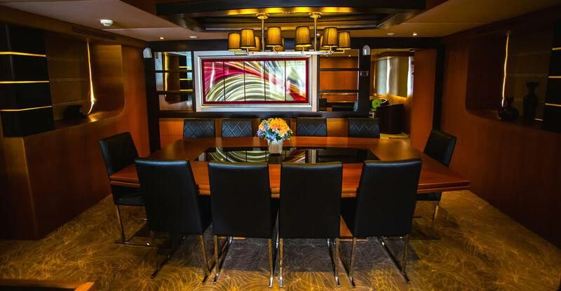 a room with a table and chairs aboard STAR OF THE SEA Yacht for Sale