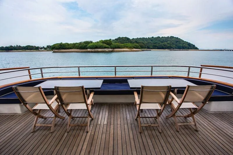 a group of chairs on a dock by a body of water aboard STAR OF THE SEA Yacht for Sale
