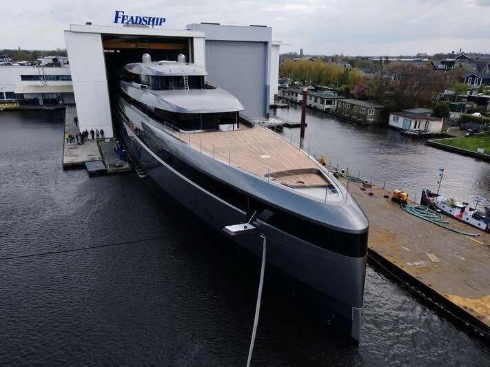 a large boat docked at a dock aboard OBSIDIAN Yacht for Sale