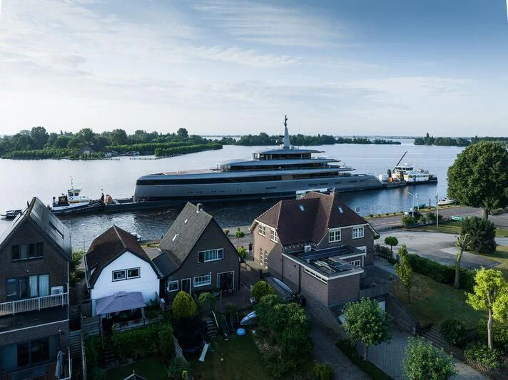 a large ship docked at a harbor aboard OBSIDIAN Yacht for Sale
