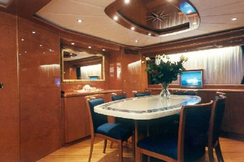a room with a table and chairs aboard CHARLY BOY Yacht for Sale