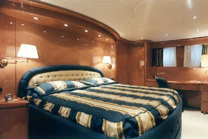 a bed with a blue comforter aboard CHARLY BOY Yacht for Sale