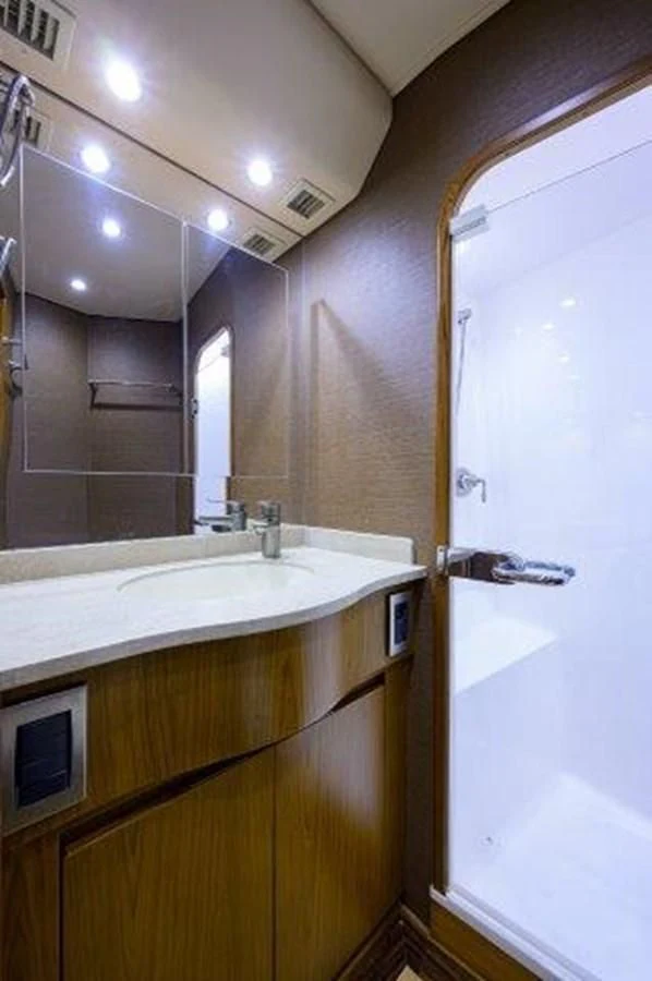 a bathroom with a sink and a mirror aboard LITTLE AUDREY Yacht for Sale