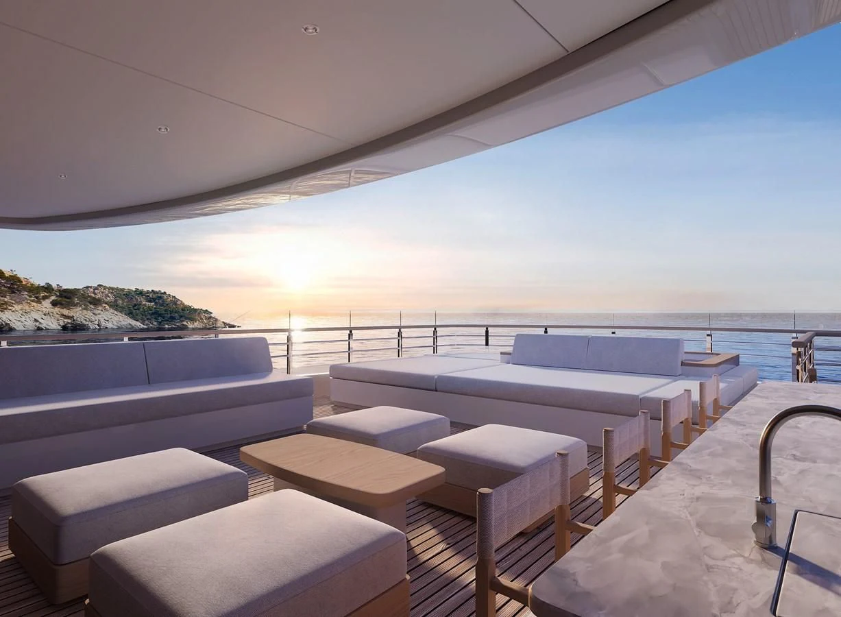 a lounge area with a large body of water in the background aboard LES CINQ Yacht for Sale