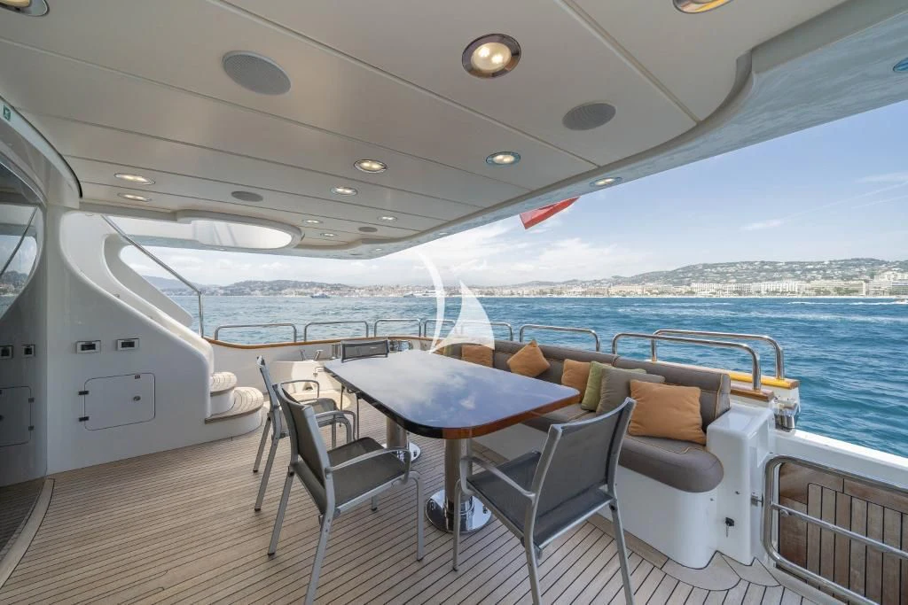 a boat with a table and chairs aboard QUID PRO QUO Yacht for Sale