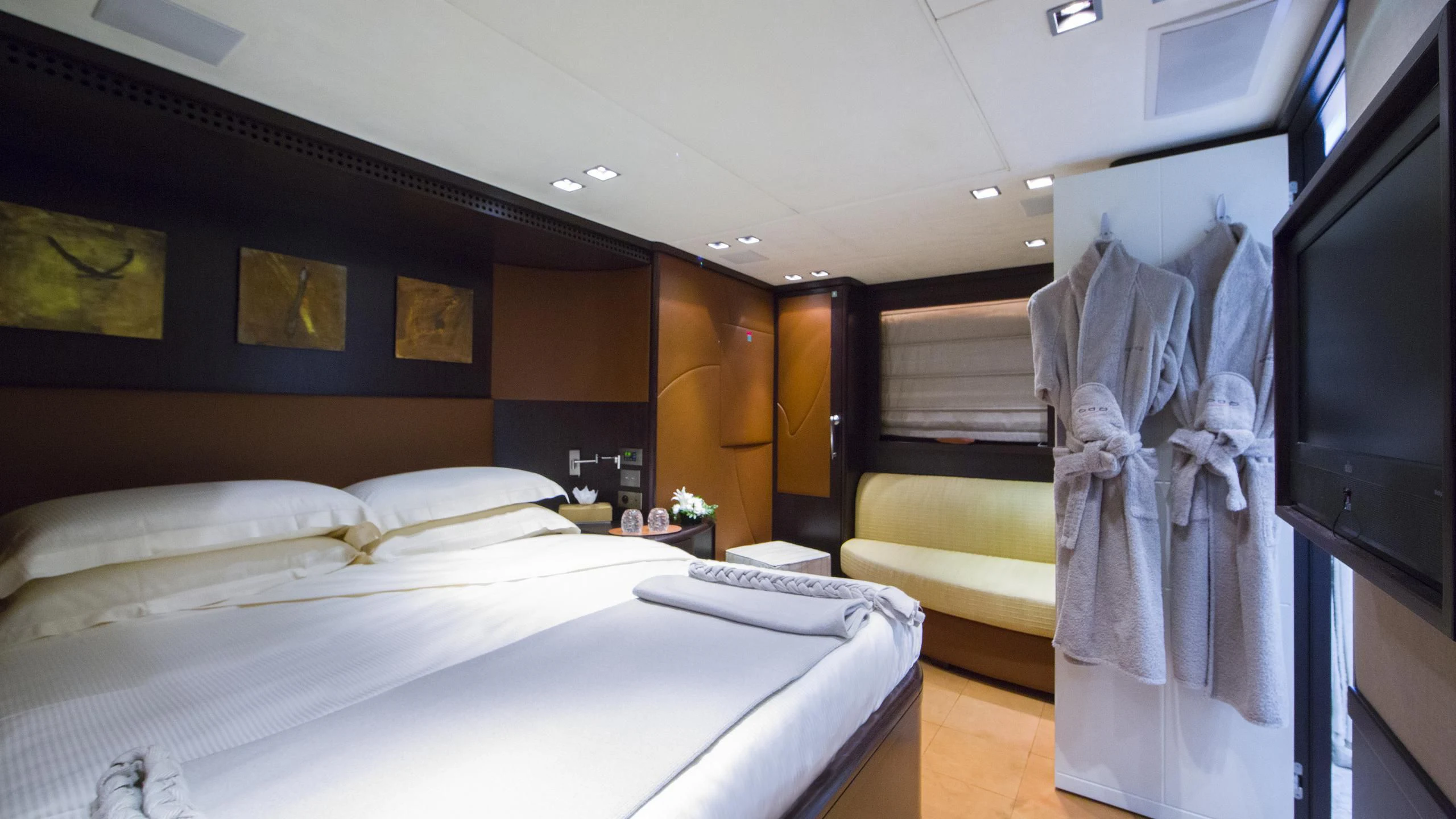 a room with a bed and a television aboard QUID PRO QUO Yacht for Sale