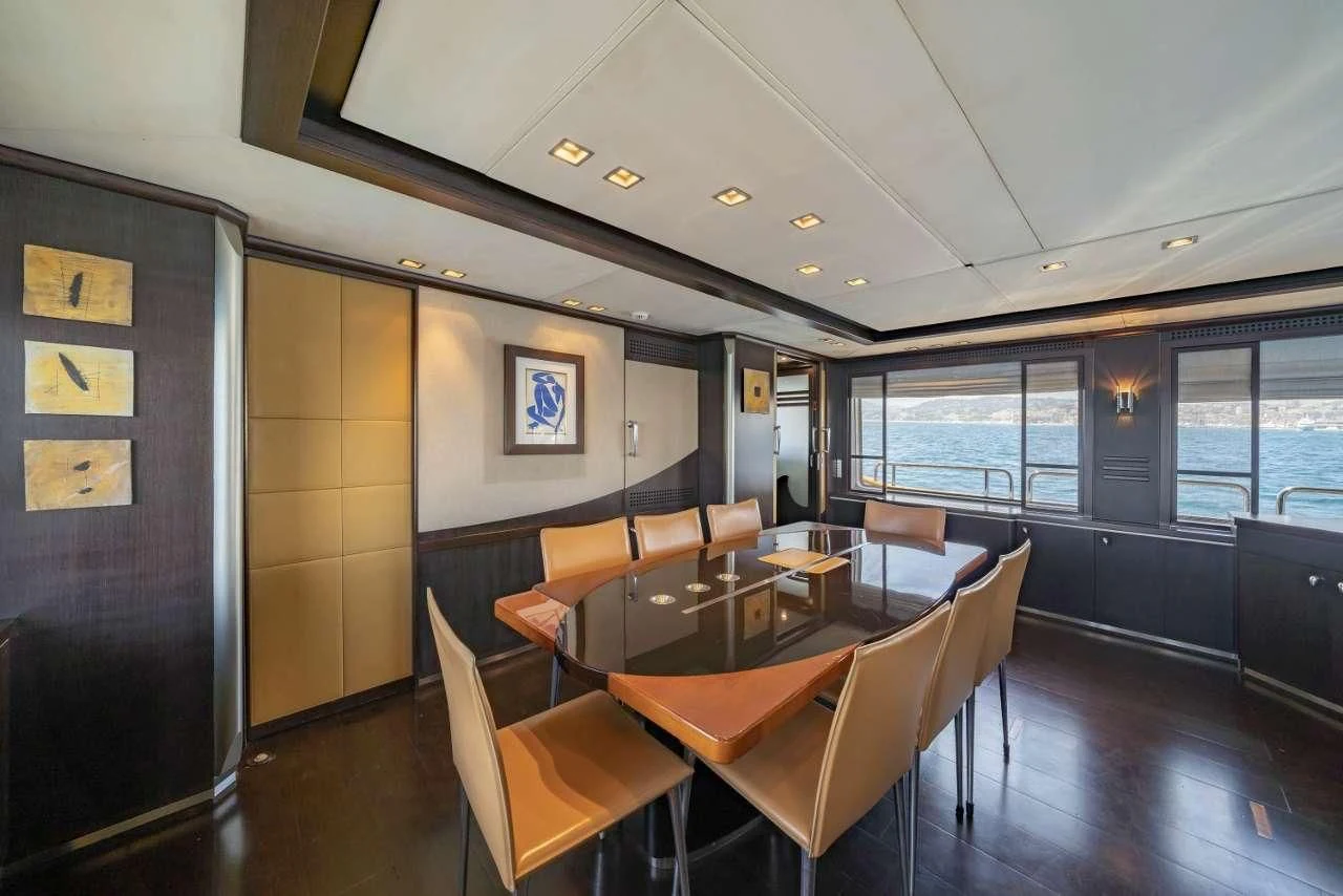 a dining room with a table and chairs aboard QUID PRO QUO Yacht for Sale