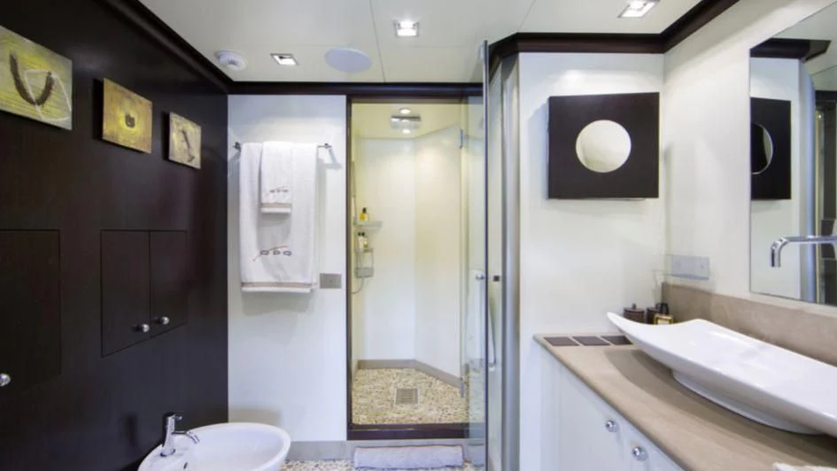 a bathroom with a glass shower aboard QUID PRO QUO Yacht for Sale