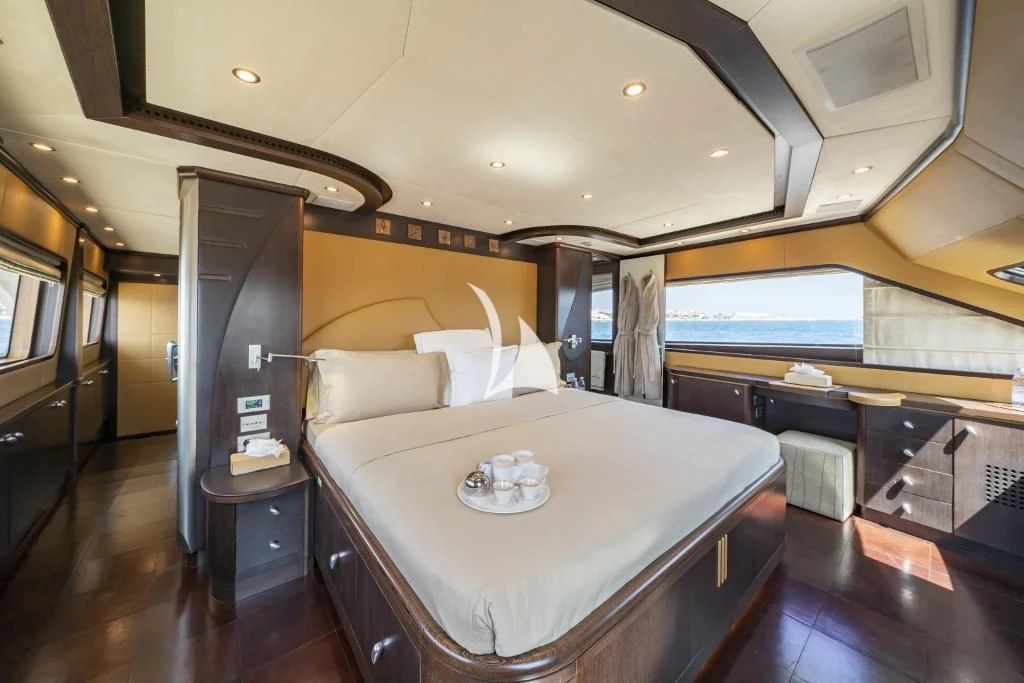 a room with a bed and a table aboard QUID PRO QUO Yacht for Sale