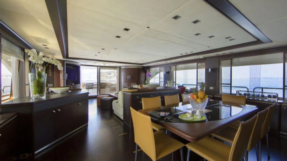 a room with a table and chairs aboard QUID PRO QUO Yacht for Sale