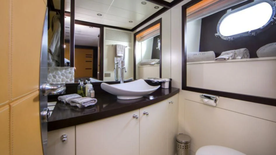 a bathroom with a sink and a mirror aboard QUID PRO QUO Yacht for Sale