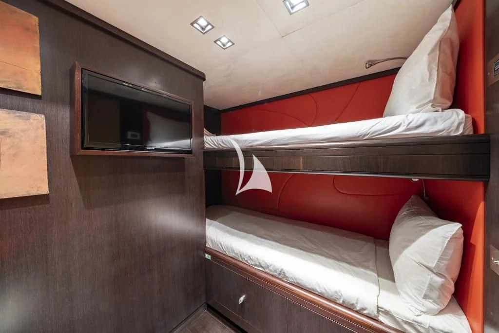 a room with a bed and a television aboard QUID PRO QUO Yacht for Sale