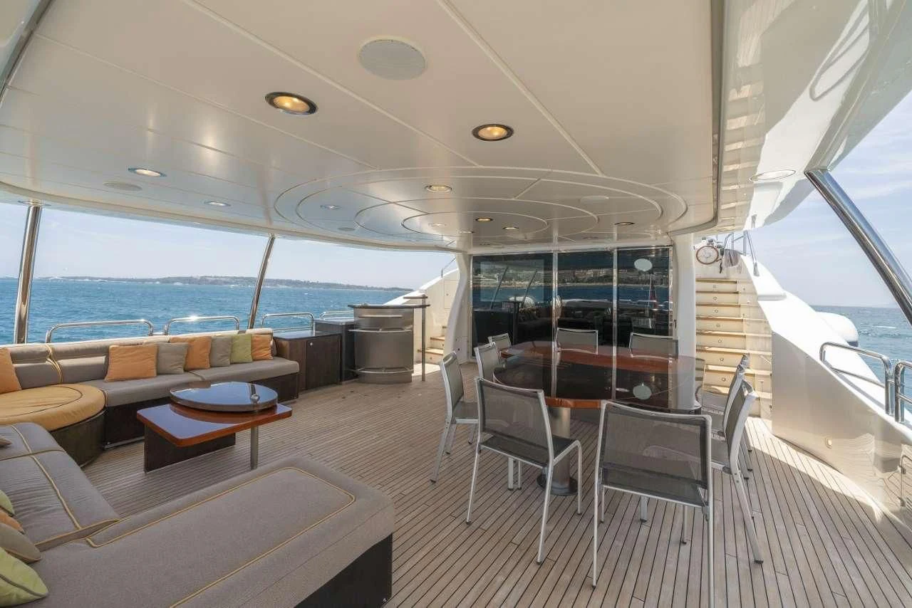 a room with a table chairs and a large window aboard QUID PRO QUO Yacht for Sale