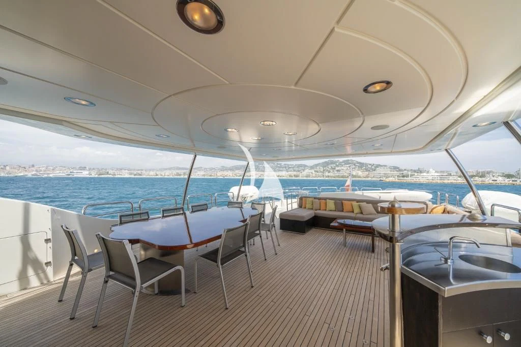 a room with tables and chairs aboard QUID PRO QUO Yacht for Sale