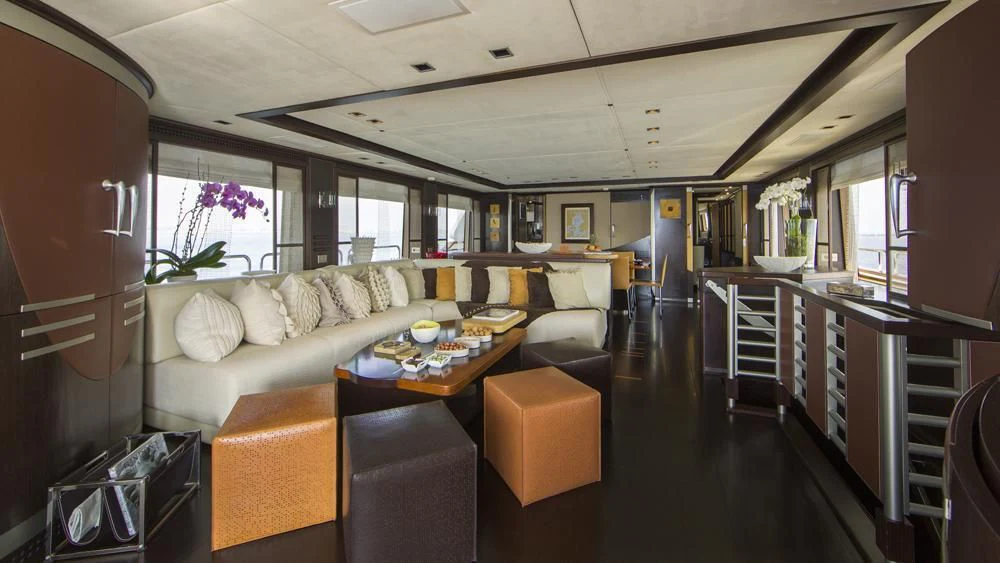 a train with a couch and coffee table aboard QUID PRO QUO Yacht for Sale