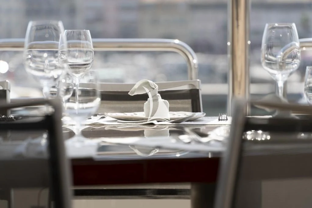 a glass table with a white bow and a white bow on it aboard QUID PRO QUO Yacht for Sale