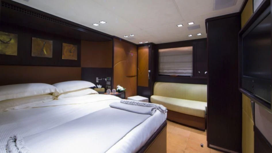 a room with a bed and a desk aboard QUID PRO QUO Yacht for Sale