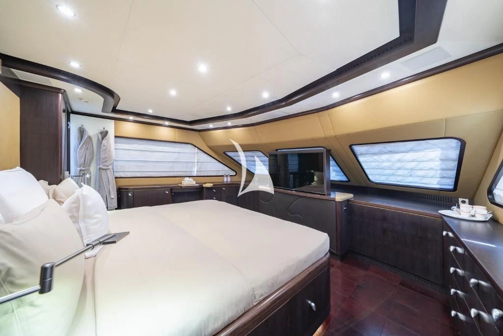 a room with a bed and a television aboard QUID PRO QUO Yacht for Sale