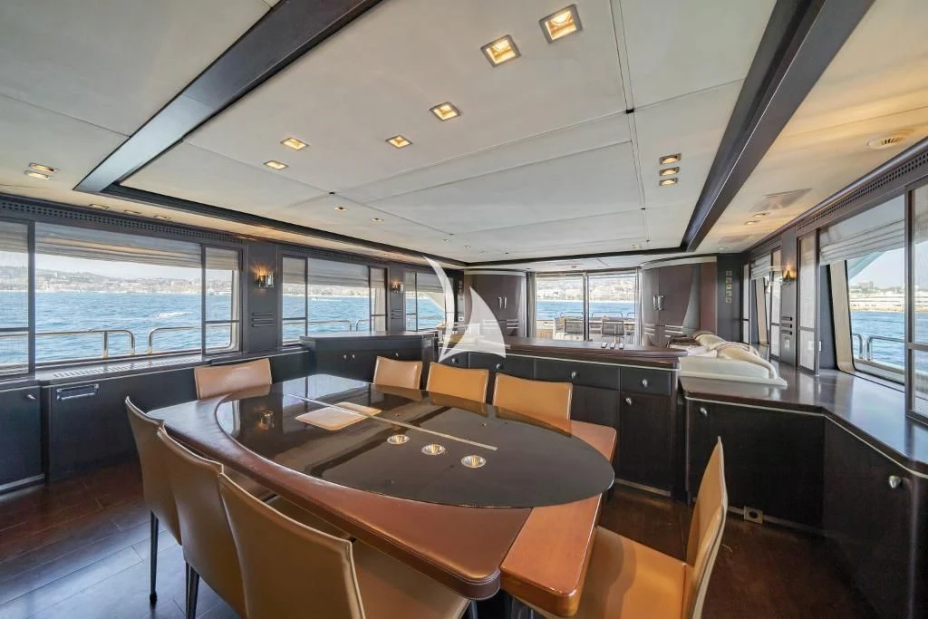 a large room with a table and chairs aboard QUID PRO QUO Yacht for Sale