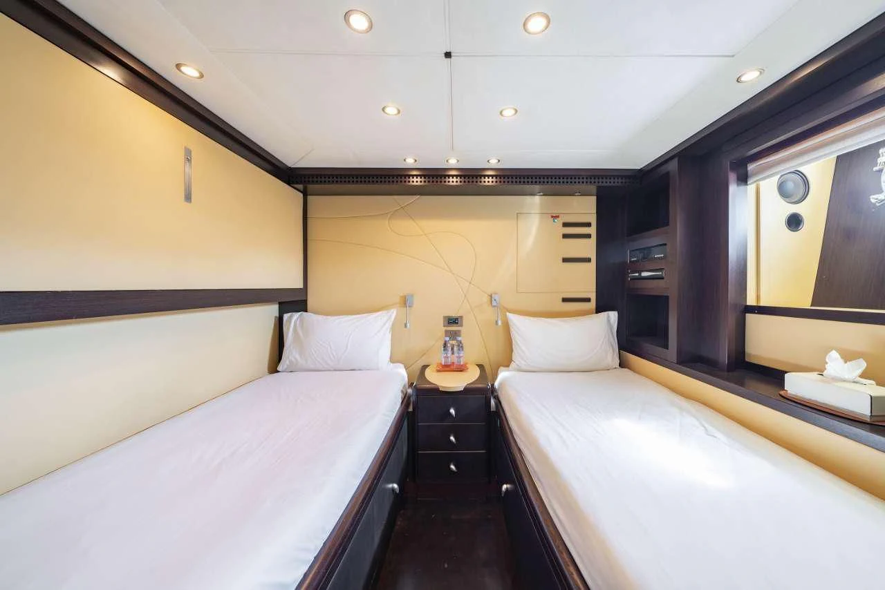a room with a bed and a mirror aboard QUID PRO QUO Yacht for Sale