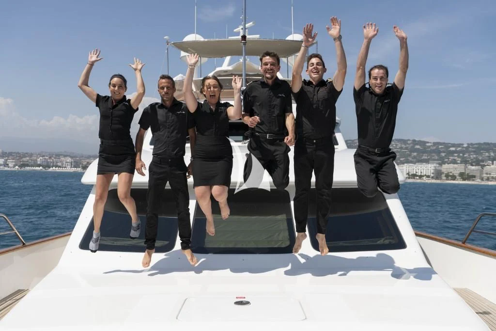 a group of people jumping on a boat aboard QUID PRO QUO Yacht for Sale