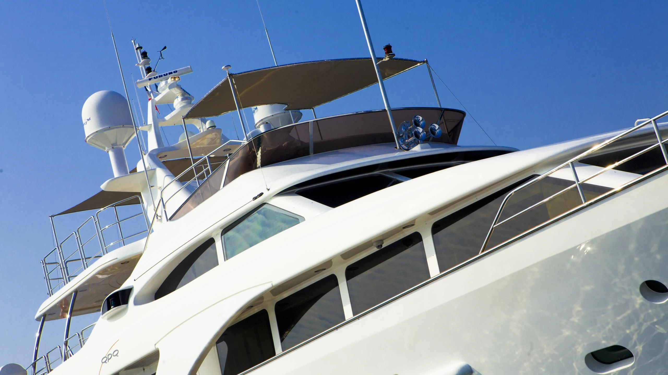 a white yacht with people on it aboard QUID PRO QUO Yacht for Sale