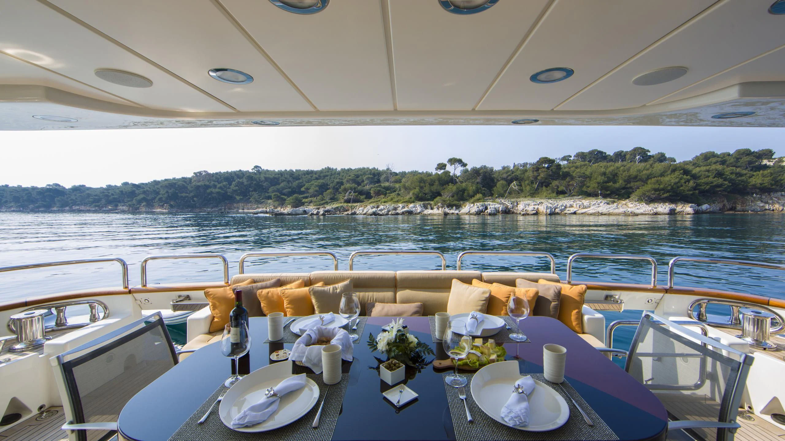 a table set for a dinner party aboard QUID PRO QUO Yacht for Sale