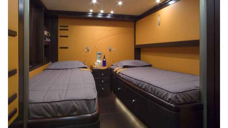 a room with two beds aboard QUID PRO QUO Yacht for Sale