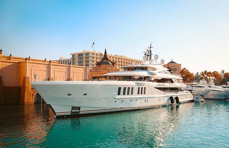 a large white boat in a harbor aboard SPECTRE Yacht for Sale