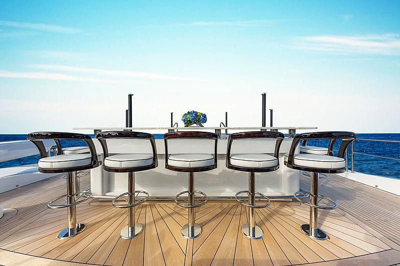 a table with chairs on it aboard SPECTRE Yacht for Sale