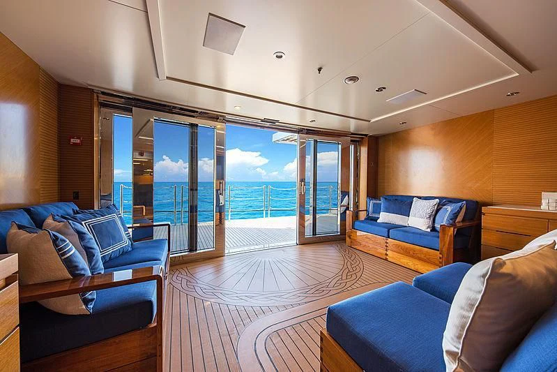 a living room with a large glass door aboard SPECTRE Yacht for Sale
