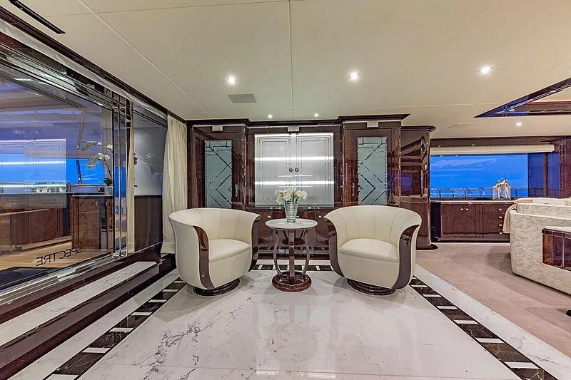 a living room with a large mirror aboard SPECTRE Yacht for Sale