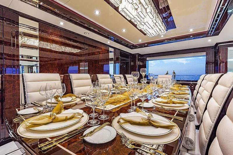 a table set with plates and glasses aboard SPECTRE Yacht for Sale