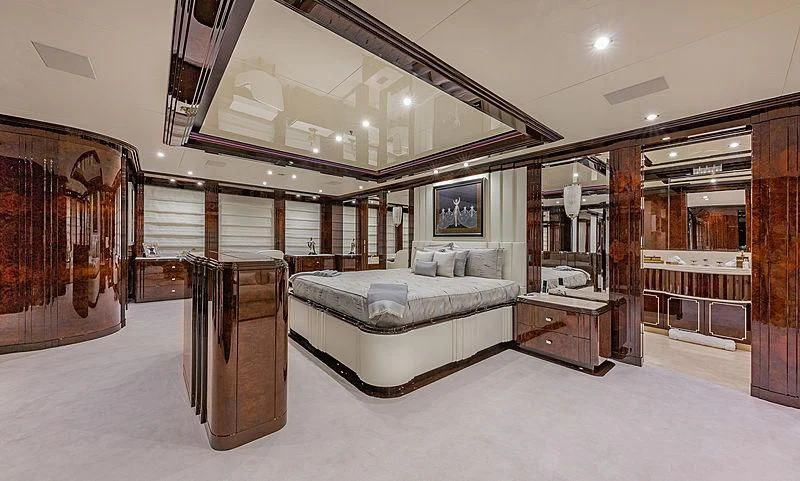 a large room with a couch and a mirror aboard SPECTRE Yacht for Sale