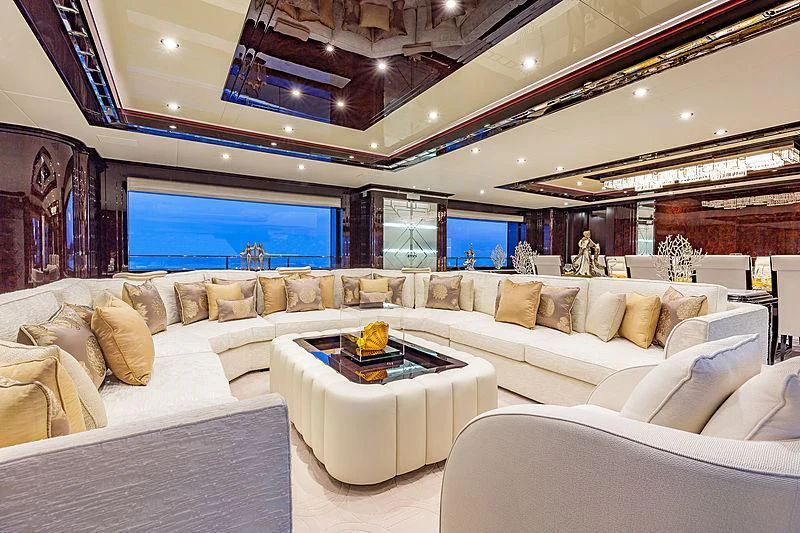 a living room with a large sofa and a large screen aboard SPECTRE Yacht for Sale