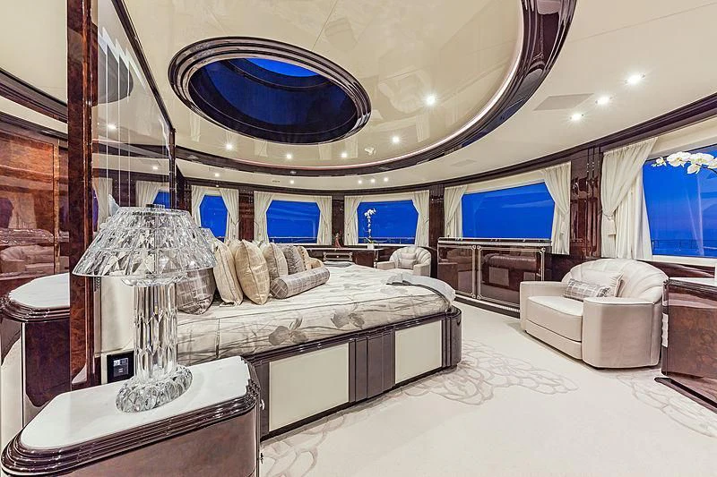 a room with a bed and a large mirror aboard SPECTRE Yacht for Sale