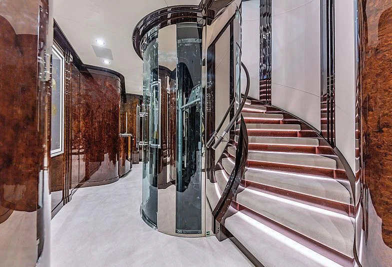 a hallway with a staircase and a railing aboard SPECTRE Yacht for Sale