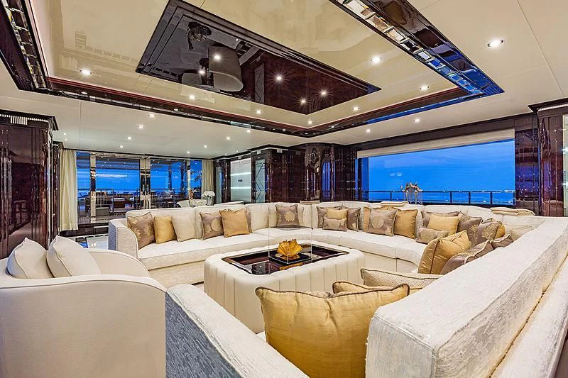 a living room with couches and a large window aboard SPECTRE Yacht for Sale