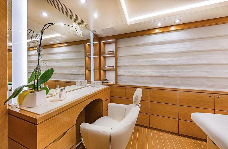a room with a desk and a chair and a plant in it aboard SPECTRE Yacht for Sale