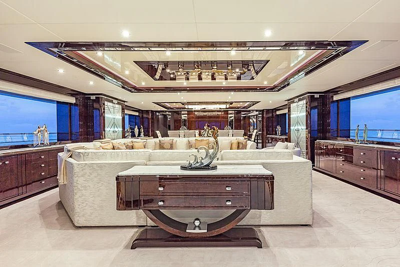 a large room with a couch and a table aboard SPECTRE Yacht for Sale