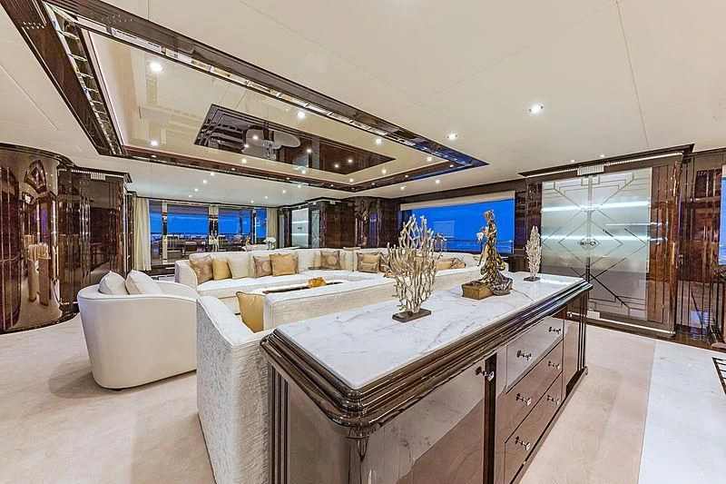 a large room with a large white table and a large white couch aboard SPECTRE Yacht for Sale